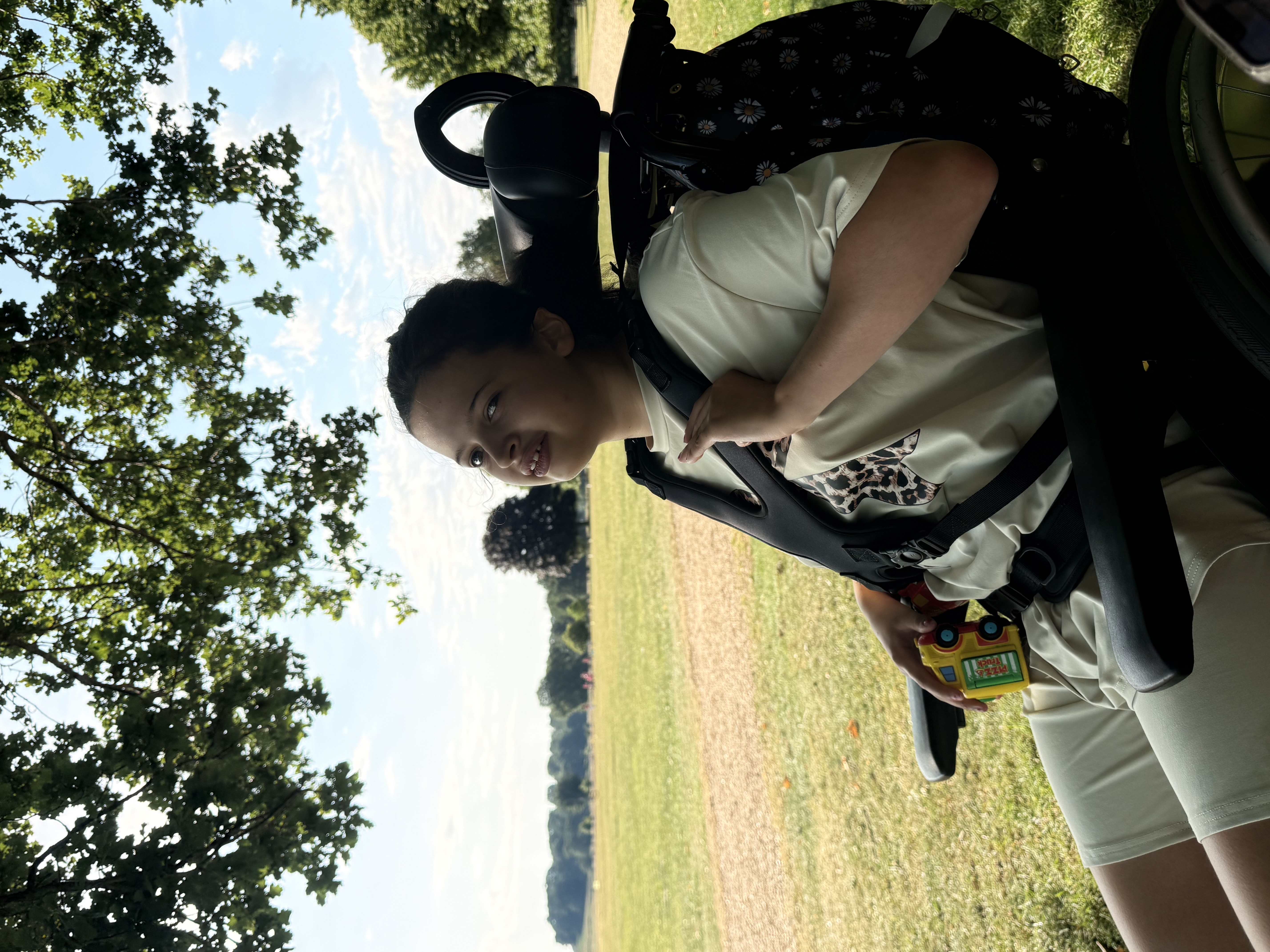 Lucie in her wheelchair, enjoying the outdoors